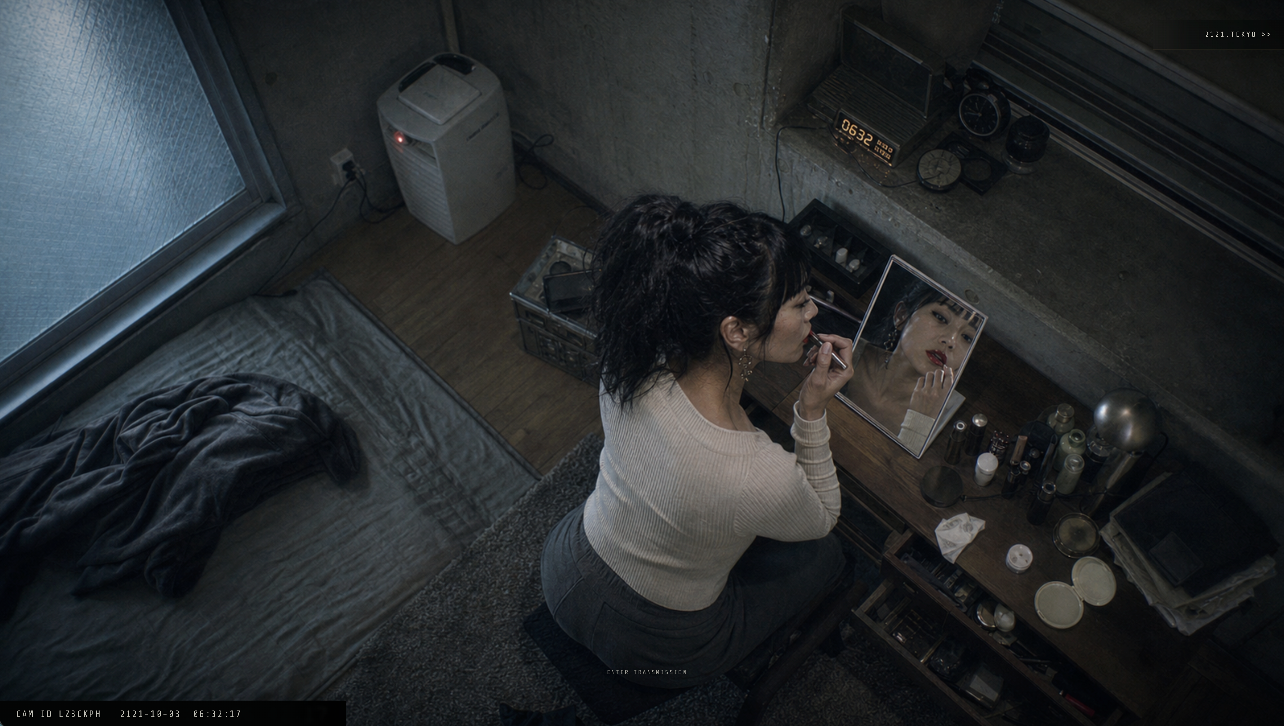 A woman applies lip color at a mirror in a dim Tokyo room, viewed through the 2121.tokyo surveillance interface.